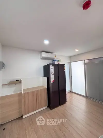 Modern kitchen with sleek appliances and wooden cabinetry in a bright, airy space.