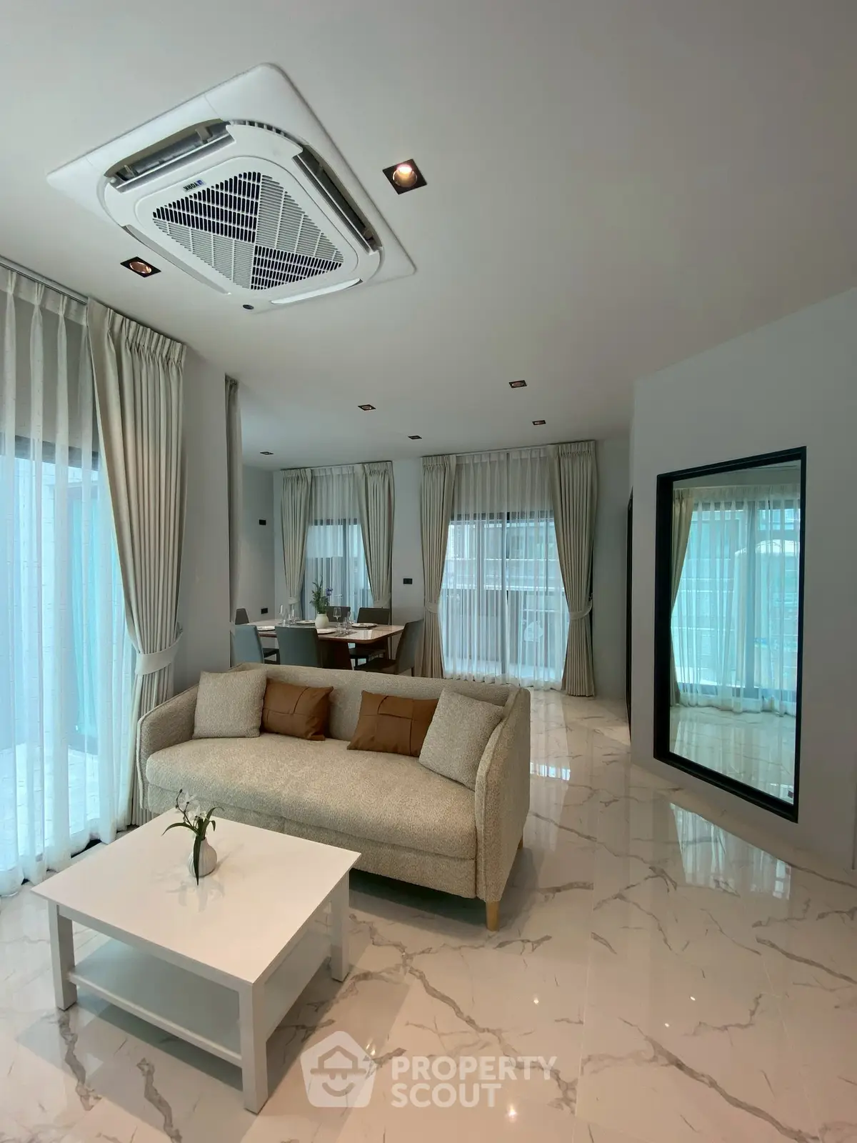 Spacious modern living room with elegant decor and large windows