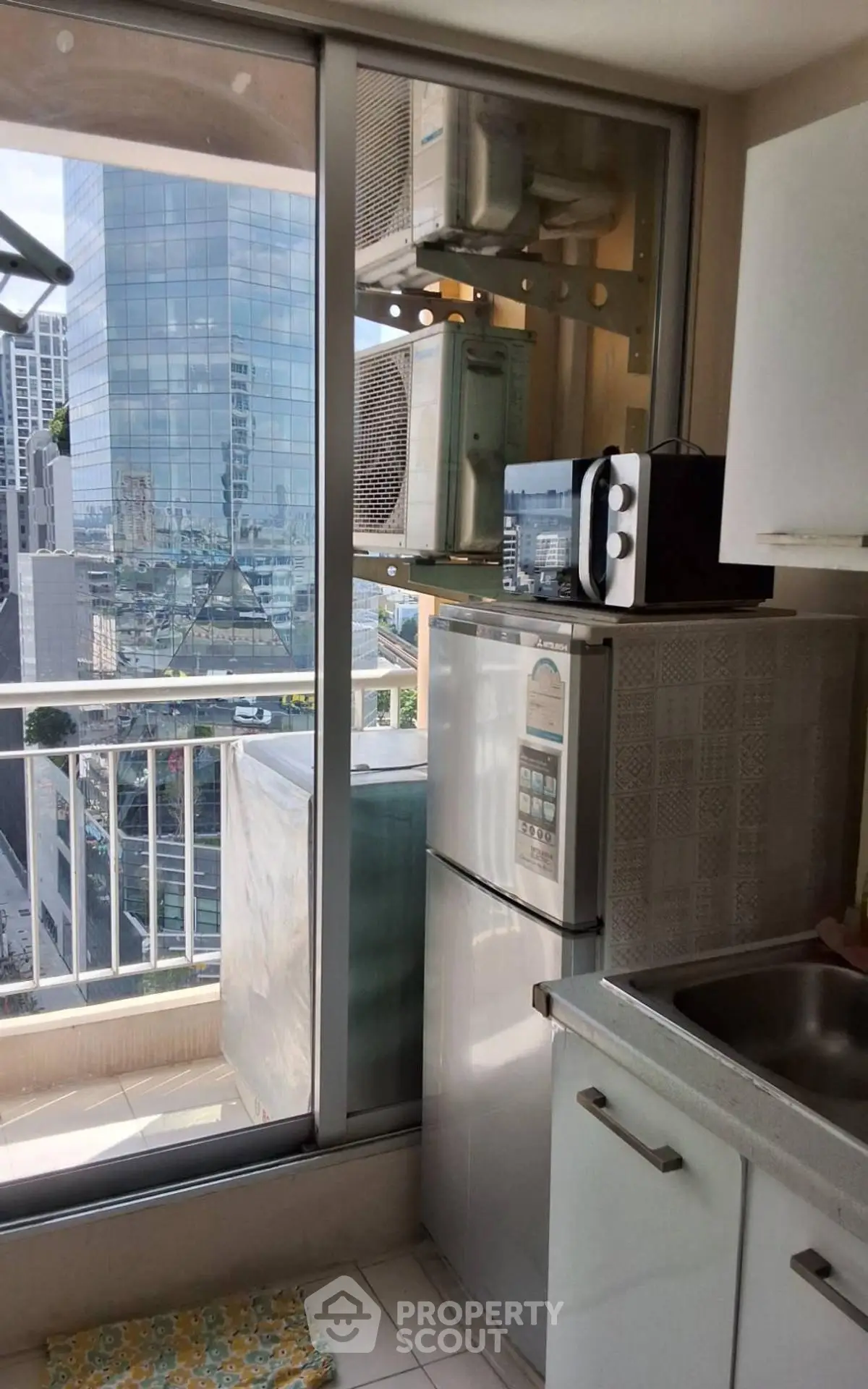 Modern kitchen with city view, featuring sleek appliances and ample natural light.