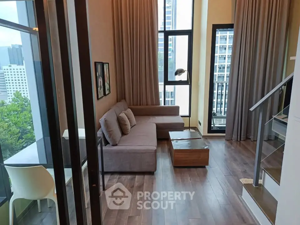Modern living room with large windows and city view in a stylish apartment