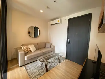 Cozy living room with modern sofa and glass coffee table, perfect for relaxation.