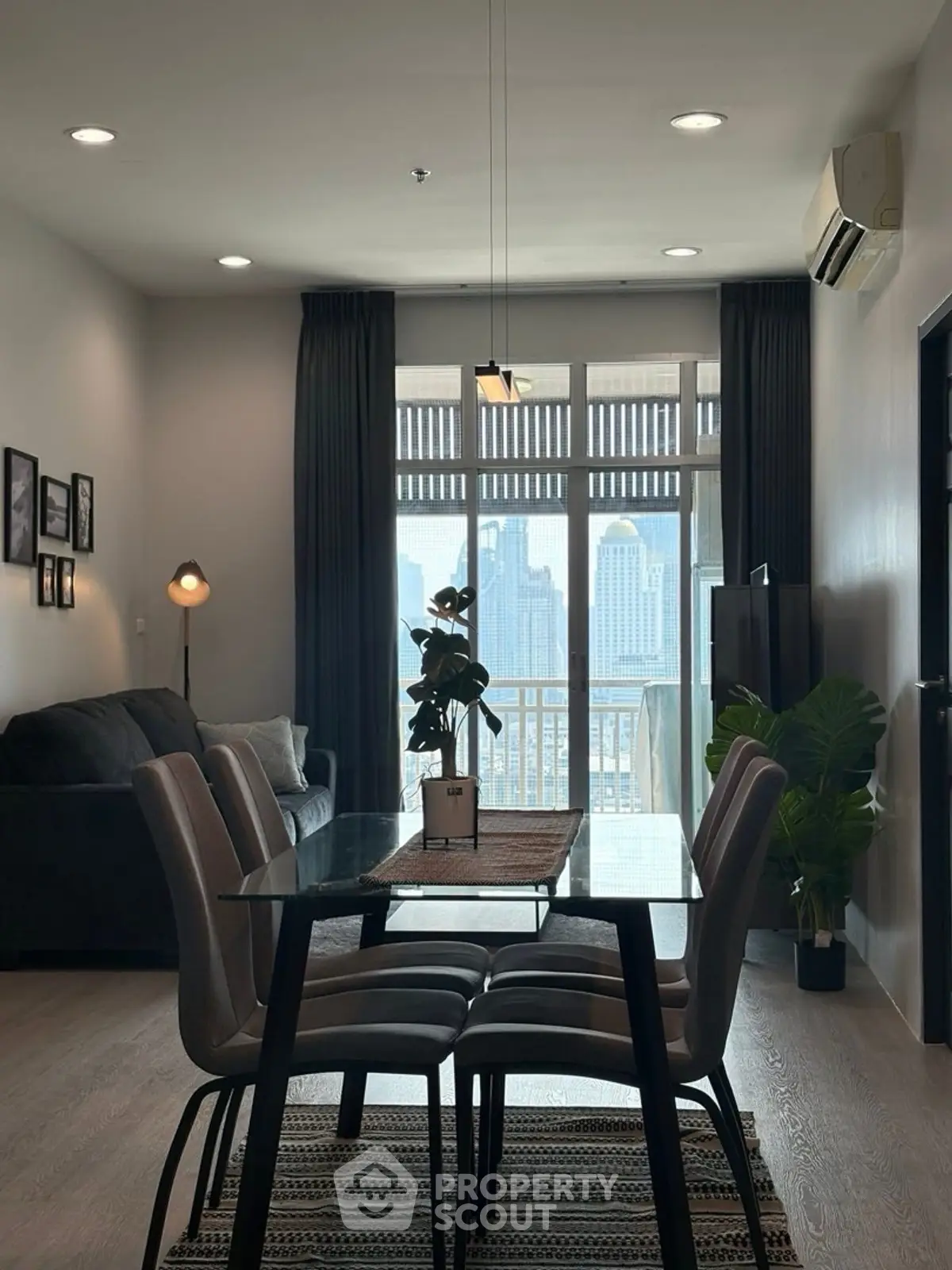 Modern living room with dining area and city view balcony