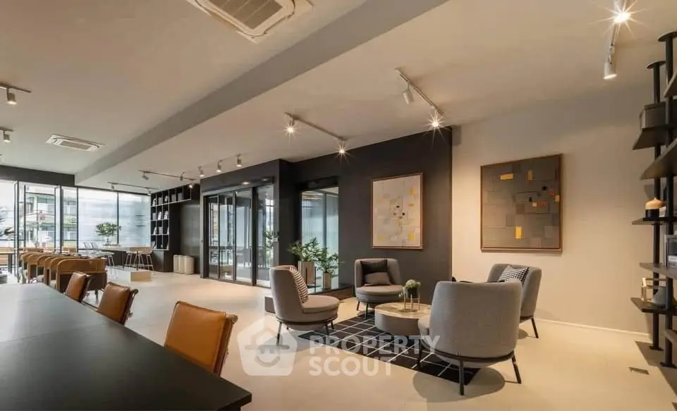 Modern living room with stylish furniture and open layout, featuring elegant lighting and contemporary decor.