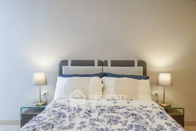 Cozy bedroom with elegant bedding and ambient lighting, perfect for relaxation and comfort.