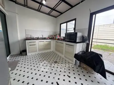 Spacious kitchen with modern appliances and open layout, perfect for culinary enthusiasts.