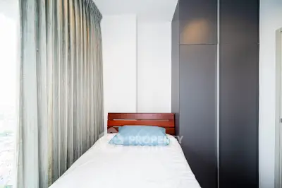 Cozy bedroom with single bed and modern wardrobe, perfect for minimalist living.
