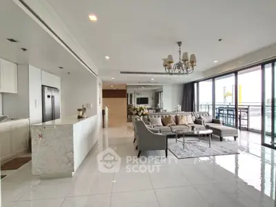 Luxurious open-plan living room with elegant decor and spacious balcony view.