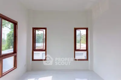 Bright and airy room with large windows and minimalist design.