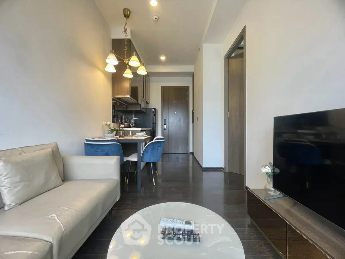 Modern living room with open kitchen and elegant dining area in a stylish apartment.
