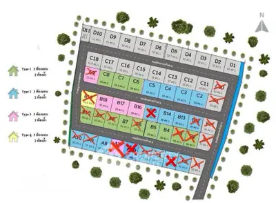 Colorful real estate plot map with various lot sizes and types, surrounded by greenery.