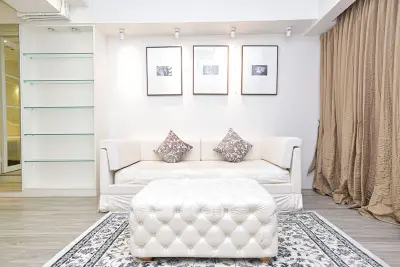 Elegant living room with plush white sofa, stylish decor, and cozy ambiance.
