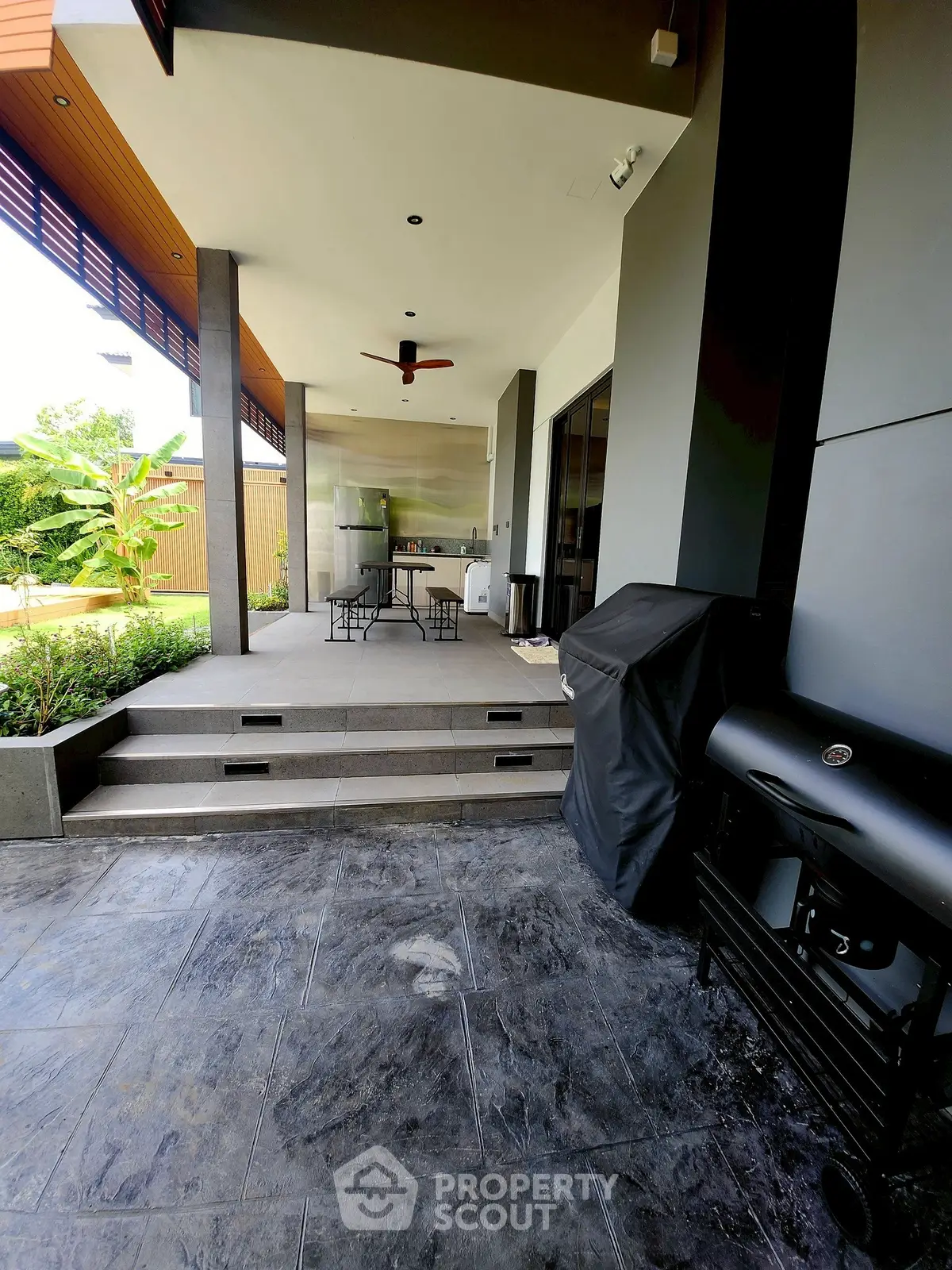 Modern outdoor patio with BBQ grill and stylish seating area
