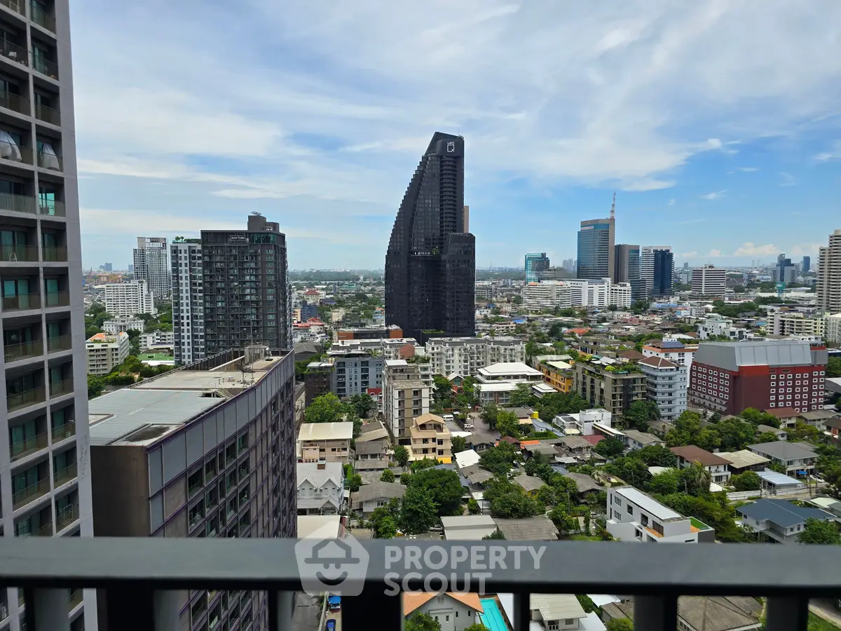 Stunning cityscape view from a high-rise balcony showcasing modern architecture and urban skyline.