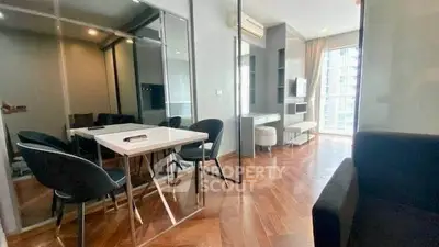 Modern living room with sleek design and hardwood floors in a high-rise apartment.