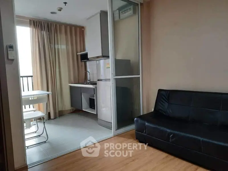 Modern studio apartment with compact kitchen and cozy living area