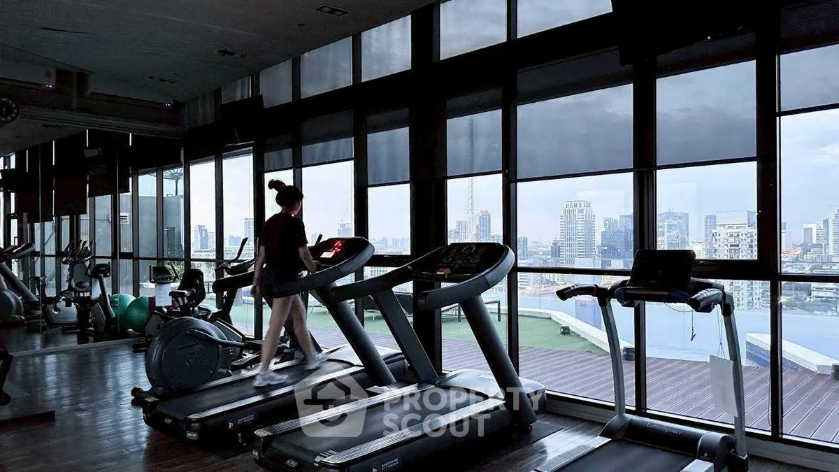Modern gym with city view and state-of-the-art equipment