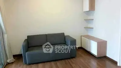 Modern living room with sleek gray sofa and minimalist shelving, perfect for cozy urban living.