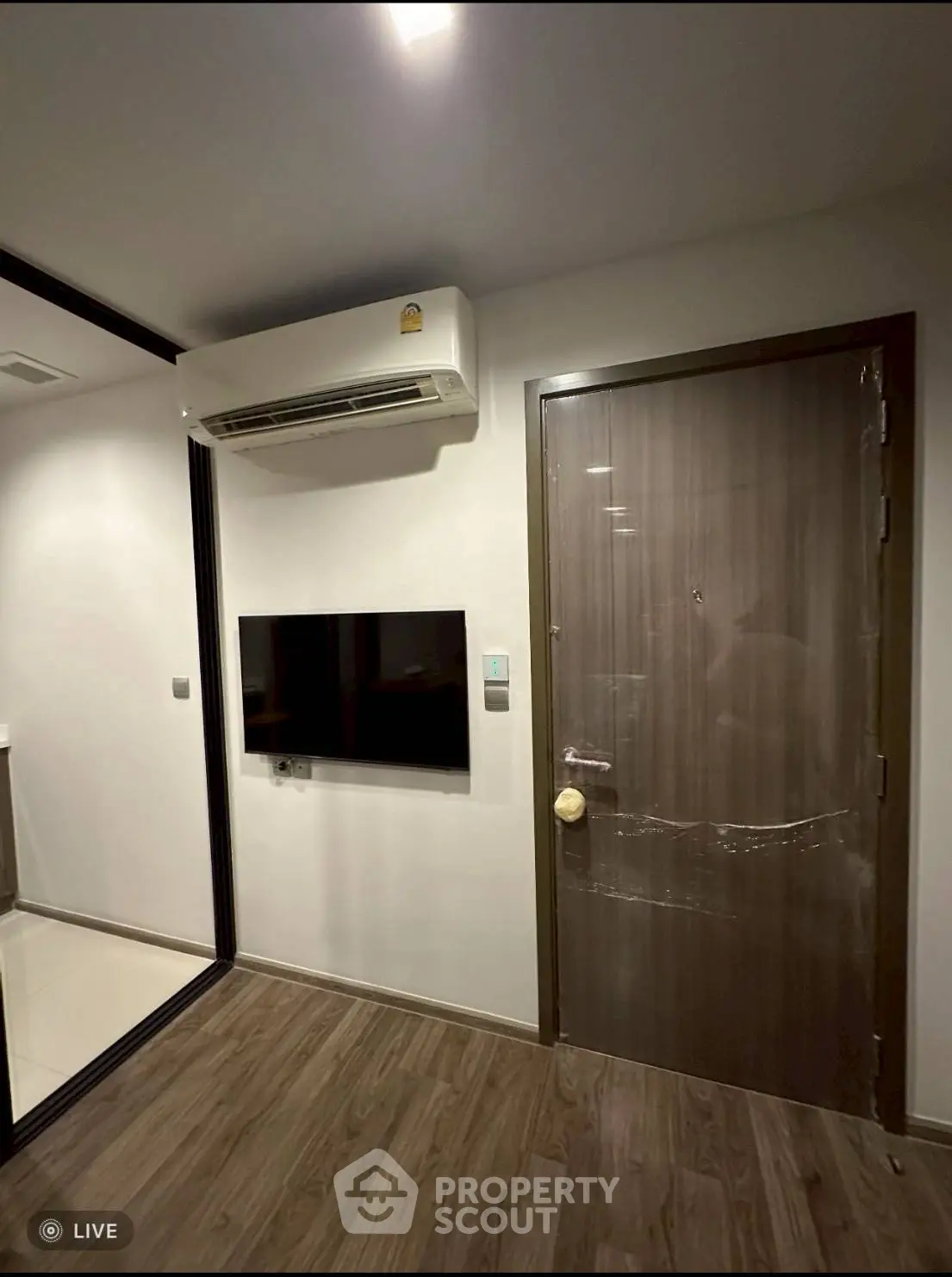 Modern apartment interior with air conditioning and wall-mounted TV
