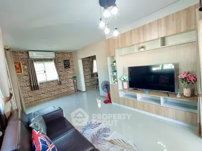 Spacious living room with modern decor and large TV unit