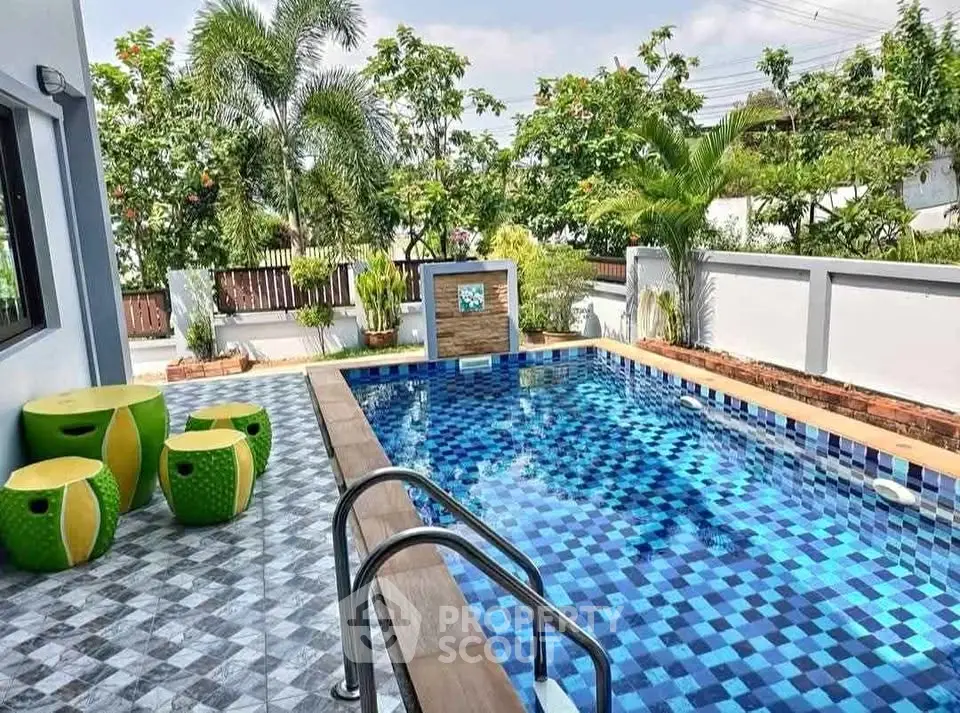 Stunning private pool with vibrant tiles and lush greenery, perfect for relaxation and entertainment.