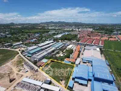 Aerial view of industrial area with warehouses and open land, ideal for development opportunities.