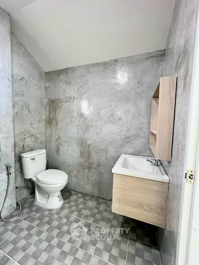 Modern minimalist bathroom with sleek gray tiles and wooden vanity