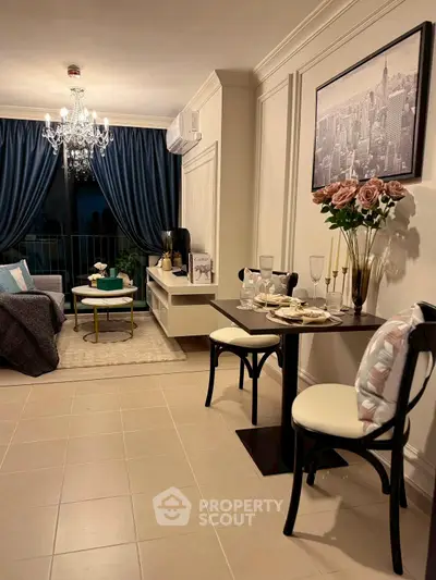 Elegant living room with chandelier and cityscape artwork, featuring cozy dining area and stylish decor.