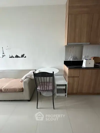Modern compact living room with integrated kitchen and cozy sofa