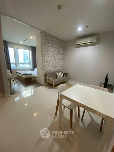 Modern apartment interior with open living and dining area, featuring stylish furniture and natural light.