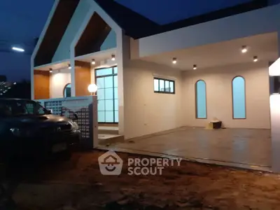 Modern single-story house with spacious garage and stylish exterior lighting.