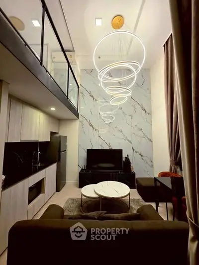 Luxurious modern living room with high ceilings and elegant lighting in a stylish apartment.