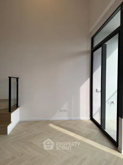 Spacious modern interior with large windows and elegant flooring, perfect for natural light lovers.