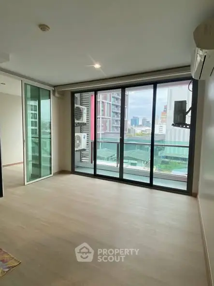 Spacious modern living room with large windows and city view