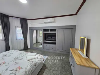 Spacious bedroom with modern decor and built-in wardrobe