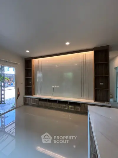 Modern living room with built-in shelving and sleek design