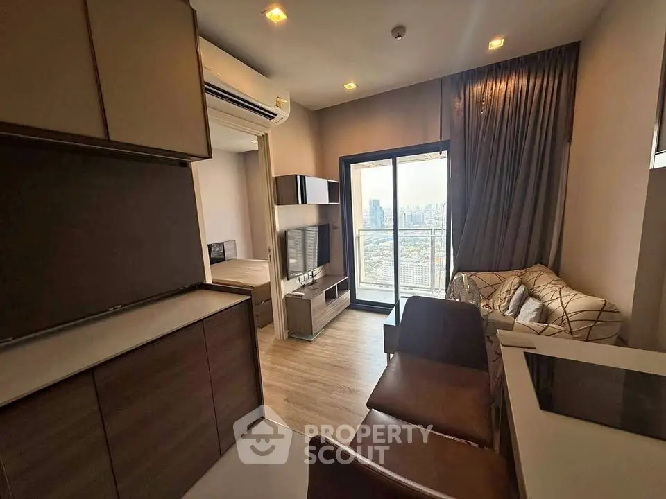 Modern apartment interior with open living area and city view balcony.