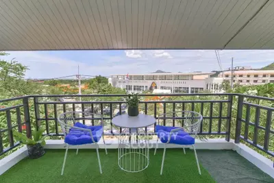 Charming balcony with seating and scenic view, perfect for relaxation and enjoying the outdoors.