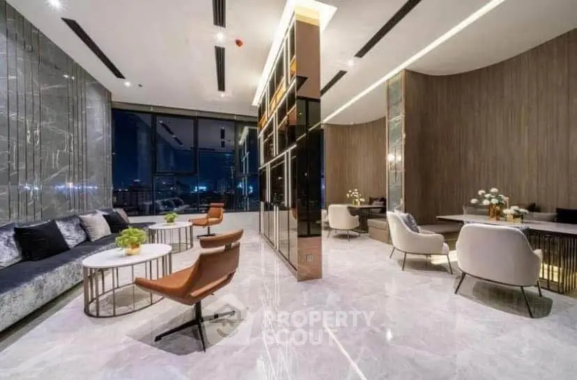 Luxurious modern living room with marble floors, elegant furniture, and city view at night.