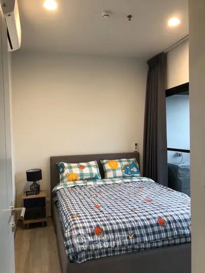 Cozy bedroom with stylish decor and ample natural light
