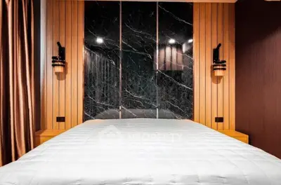 Luxurious bedroom with elegant wood paneling and modern lighting fixtures