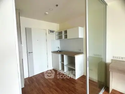 Modern compact kitchen with sleek design and wooden flooring