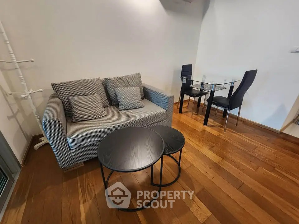 Modern living room with stylish sofa and dining area on wooden flooring