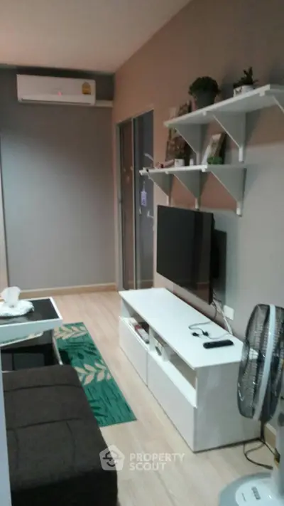 Modern living room with wall-mounted TV and air conditioning unit