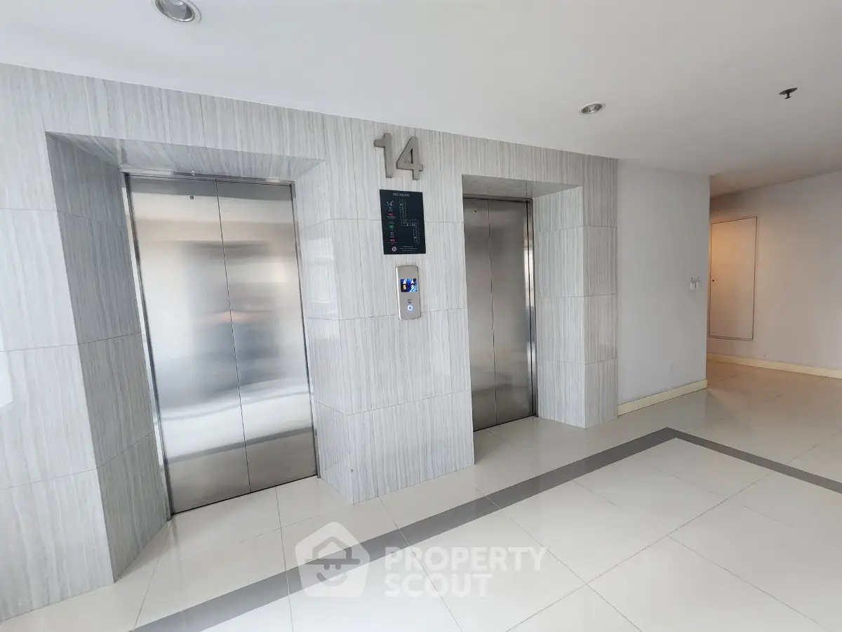 Modern building elevator lobby with sleek design and polished floors on the 14th floor.