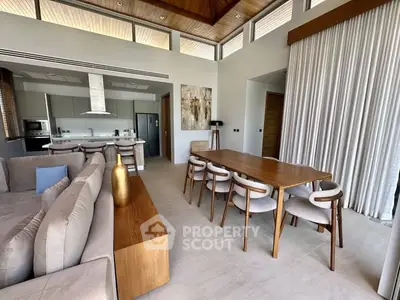 Luxurious open-plan living and dining area with modern kitchen in elegant home.