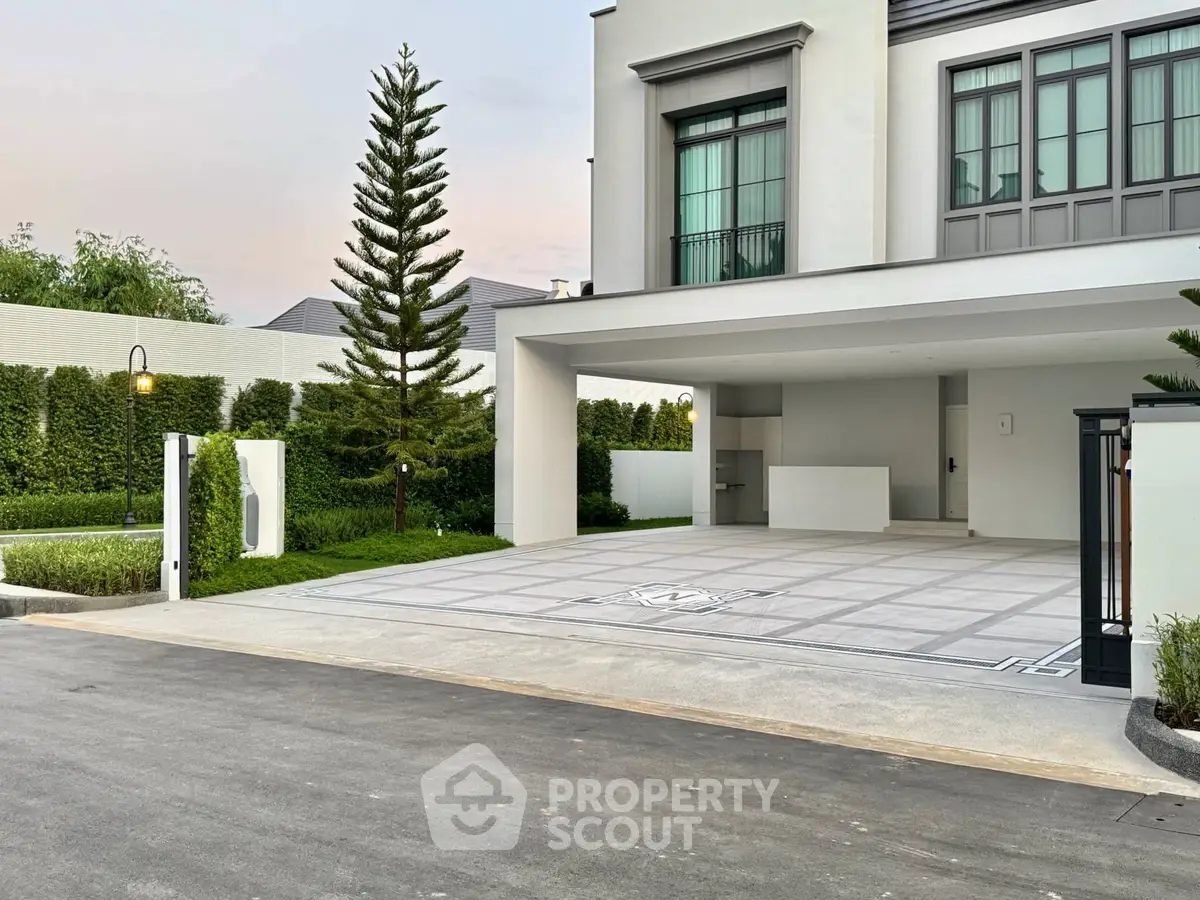 Modern luxury home with spacious driveway and lush landscaping