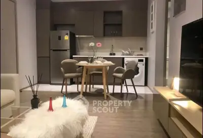 Modern open-plan kitchen and living area with stylish furniture and appliances.