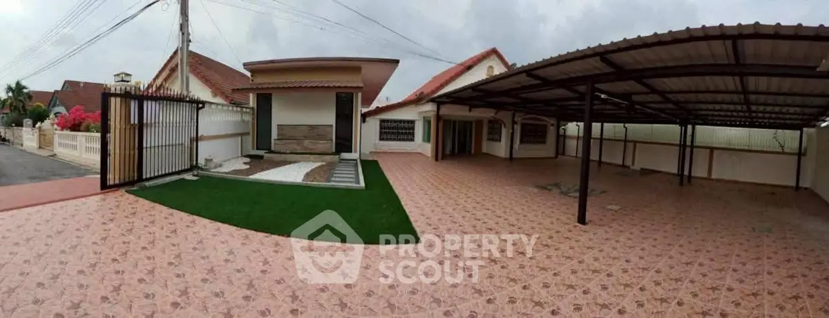 Spacious residential property with tiled driveway and covered parking area.