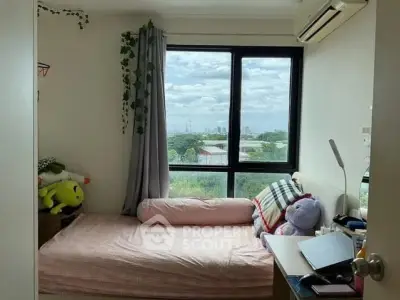 Cozy bedroom with large window offering a scenic view, perfect for relaxation and comfort.