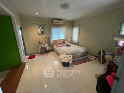 Spacious bedroom with cozy decor and natural light
